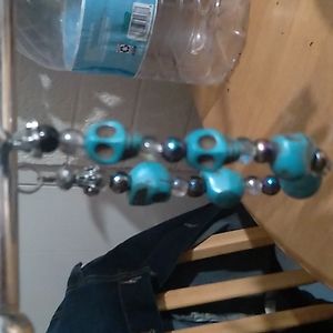 Handcrafted bracelet alien or skull beads with small opalescent beads .